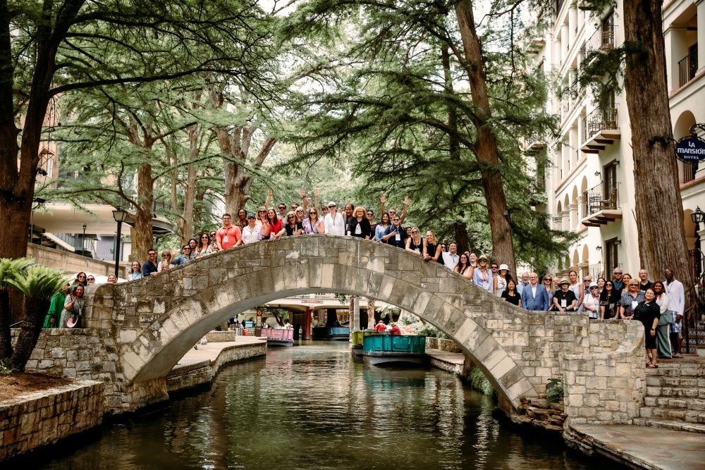 Photo of Meetings Today LIVE! attendees standing on The Selena Bridge on the San Antonio River Walk.