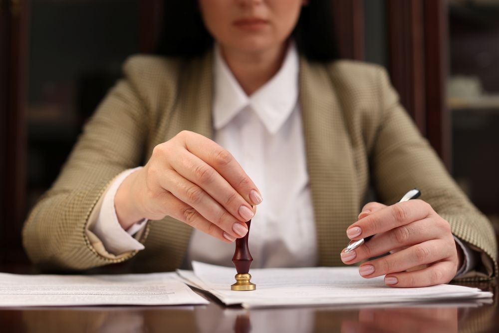 Image of a woman stamping a contract.