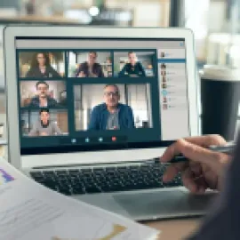 Hybrid events image of people in a virtual meeting on a laptop.